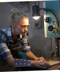 Young woman using a bandsaw, wearing Built Tough Breathable Cut Resistant Wrist Sleeves And Forearm Guards for protection.