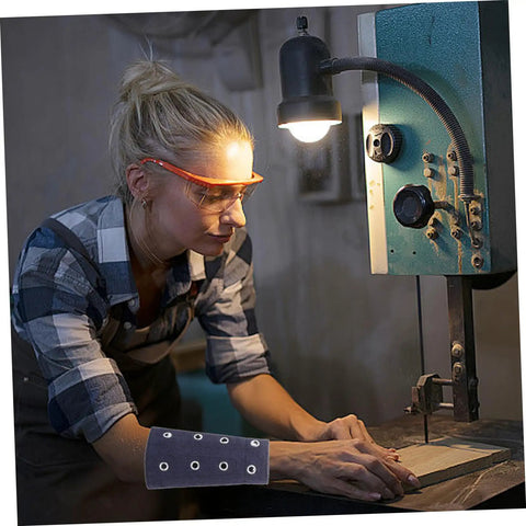 Young woman using a bandsaw, wearing Built Tough Breathable Cut Resistant Wrist Sleeves And Forearm Guards for protection.