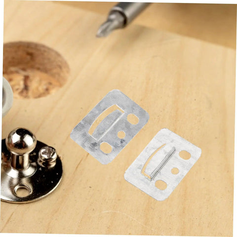 100 Piece Rugged Stainless Steel Gusset Plates Heavy Duty Wall Panel Clamps on wooden surface for DIY home builds.