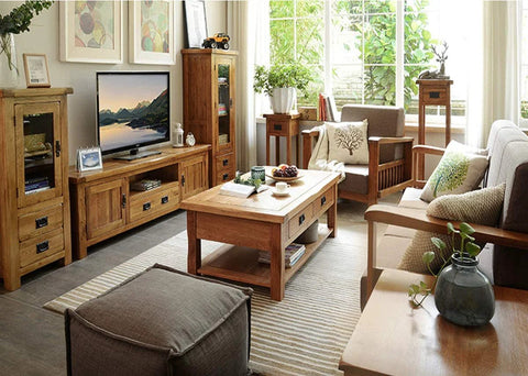 Cozy living room with wooden furniture and decor, featuring a coffee table, TV stand, and sofa, creating a warm and inviting atmosphere.