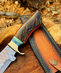 Dope Copper Damascus Fixed Blade Knife with Resin Handle and Premium Leather Sheath on wood surface for outdoor use