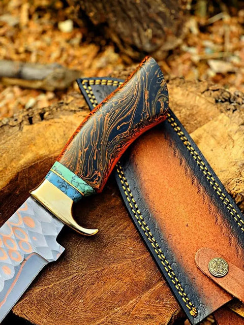 Dope Copper Damascus Fixed Blade Knife with Resin Handle and Premium Leather Sheath on wood surface for outdoor use