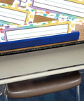 Colorful Dot Desk Nameplates Set 9.5x3 Inches For Kids Classrooms, 48 Pcs Confetti Watercolor Manuscript Name Plates on a desk.