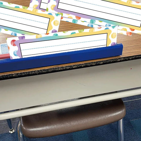 Colorful Dot Desk Nameplates Set 9.5x3 Inches For Kids Classrooms, 48 Pcs Confetti Watercolor Manuscript Name Plates on a desk.