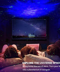 Room with Star Projector Galaxy Night Light casting nebula effects and green stars, ceiling LED lamp, kids watching movie