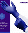 Person wearing Beaded Cuff Nitrile Exam Gloves With Textured Fingertips For Superior Grip, 4.3 Mil, Ambidextrous, 9.5 Inch, Powder Free, XS, 200 Gloves Per Box, Blue, Comfortable.