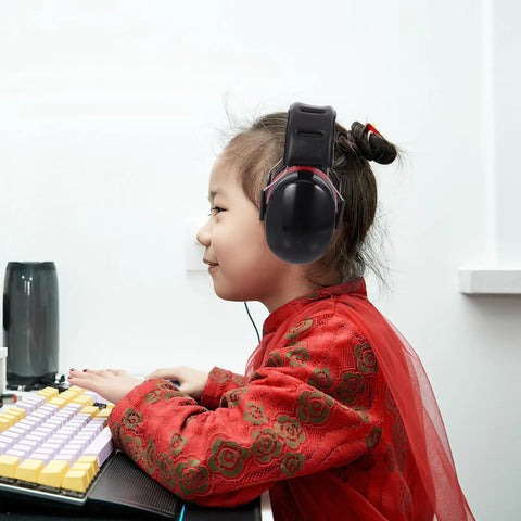 Kick Loud Noise To The Curb With Double Layer Over Ear Earmuffs designed for construction, worn by a child at a desk.