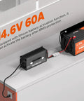 Straight Up Fast 12V LiFePO4 Lithium Battery Charger Featuring 60A High Amp Output And 14.6V Smart AC DC Quick Charge connecting to a battery.