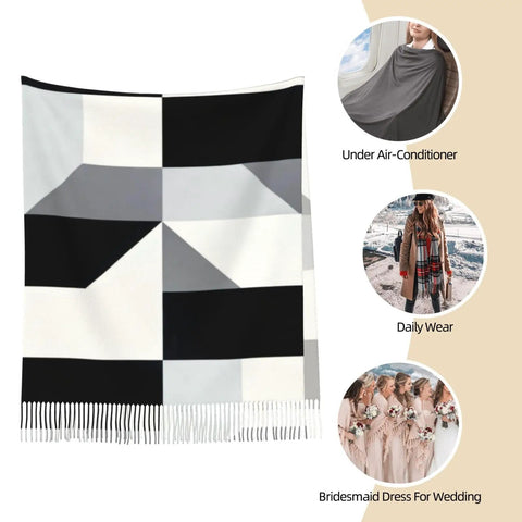 Black And White Piano Grid Winter Scarf Crafted From Plush Faux Cashmere With Extended Fringe Edges, displayed in a stylish setting.