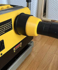 Side view of Two And A Half Inch Hose Adapter For Planer Dust Port Fits 735 And 735X Quick Friction Fit Secure Connection Keeps Dust Down No Mess Made In USA Keeps Your Shop Clean And Air Fresh installed on a planer.