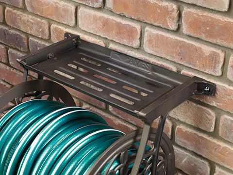 NeverLeak Decorative Wall Mount Hose Reel In Brown For Outdoor Yards Holds 125 Ft Of Five Eighths Inch Hose mounted on brick wall
