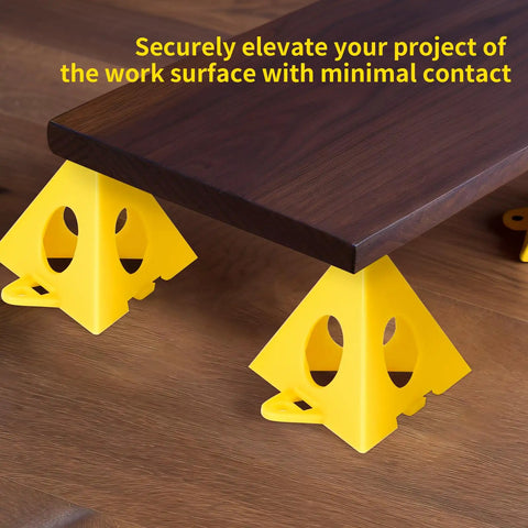 Premium Solid Gold 36 Piece Painters Pyramid Stands For Cabinet Doors And Furniture Risers lifting a wooden board off the surface.