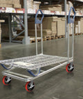 Heavy Hitter 8 Inch Industrial Casters Set Of Four on a platform cart with durable galvanized steel yokes and red polyurethane wheels.