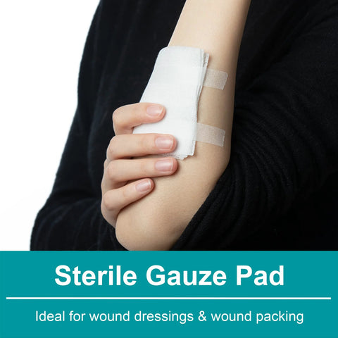 Sterile gauze pad taped to forearm with white adhesive strips