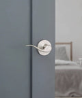 Dummy Door Lever Handle For Closets And Pantries, Right Handed Interior Pull For French Double Doors, Satin Nickel With Microban Protection, No Turn, Easy DIY Install shown installed on a grey door.
