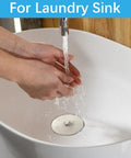 Solid 2 Pack Rubber Tub Stopper With Long Stainless Steel Beaded Chain And Heavy Duty Drain Plug For 1.5 To 2 Inch bathroom kitchen and laundry sink drains being used in a white laundry sink.