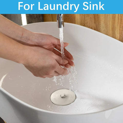 Solid 2 Pack Rubber Tub Stopper With Long Stainless Steel Beaded Chain And Heavy Duty Drain Plug For 1.5 To 2 Inch bathroom kitchen and laundry sink drains being used in a white laundry sink.