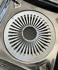 Close-up of silver grate in PVC Three Piece Shower Drain Assembly 2-Inch Black With Hair Trap And Included 4-Inch Square Riser.