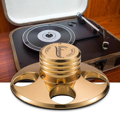 Gold metal Nobsound STB-01 LP vinyl turntable disc stabilizer weight, shown with a turntable in a zipper case.