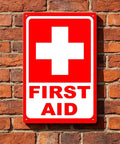 Heavy Duty 15x21 Inch Aluminum First Aid Sign, Weatherproof And Rust Free, Pre-Drilled For Easy Mounting against brick wall