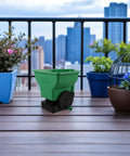 Green Handheld Seed Spreader And Planting Seeder For Veggies And Lawn Care Portable Hand Crank Broadcast Spreader Tool on balcony