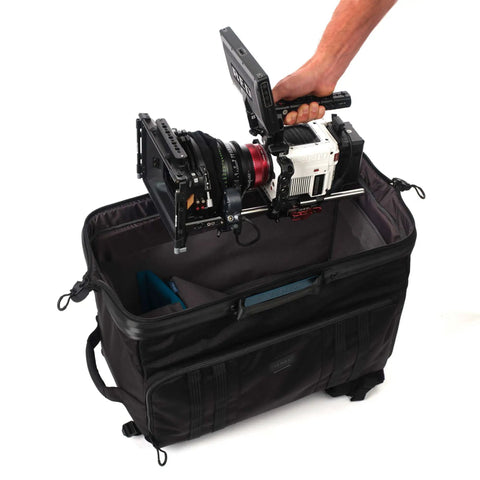 Person placing camera into Cineluxe V2 Backpack 24 for Pro Cinema Gear fits camcorders up to 20 inches with doctor bag opening