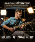 Musician playing guitar with Dimmable Bi Color LED Video Light Kit with 480 LEDs per light 3200K to 5600K CRI 96 Plus U Bracket and 75 Inch Tripod Stand for YouTube Vlogs Studio Photography and Live Streaming illuminating him.