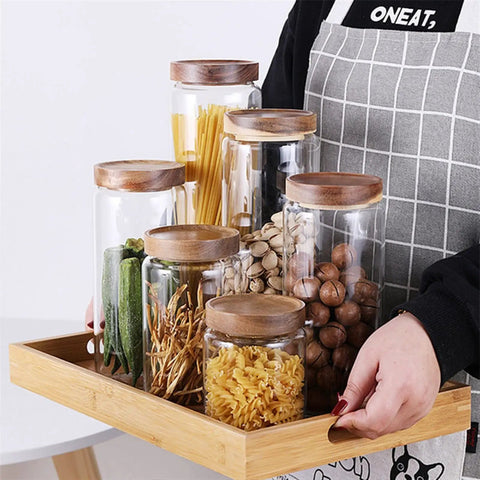 Straight Up Solid Airtight Coffee And Tea Storage Canister With Smooth Wood Lid, various canisters on a tray, showcasing storage options.