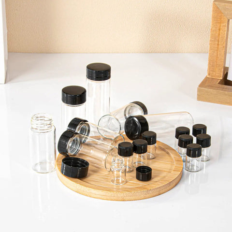 Snag A Solid Stack Of Thirty Dope Little Glass Vials Perfect For Mixing Essential Oils Or Bottling Custom Perfumes With Secure Screw Caps That Stay Leak Free During Travel And Keep Your Favorites Fresh. Collection of 30ml clear borosilicate glass vials with black screw caps on a wooden tray.