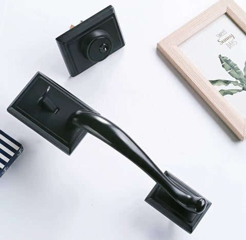 Oil Rubbed Bronze door handle set with keyed and dummy grip on white surface with decorative frame