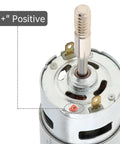 RS775 DC Motor 12V 3000 RPM dual output long shaft with positive terminal marked in close-up view