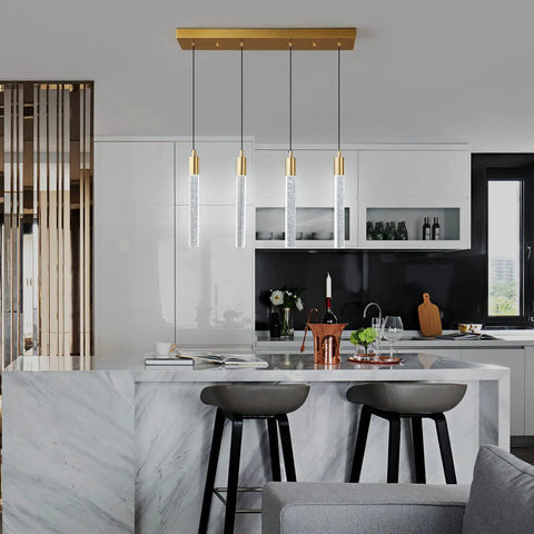 4 Light Gold Brass Pendant Light Fixture For Kitchen Island Modern Dimmable LED Bulbs above marble countertop in stylish kitchen.