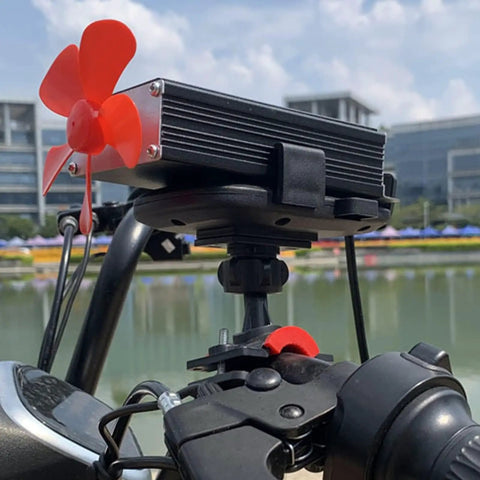 Crush Range Anxiety With This Slick Solar Generator Range Extender That Smoothly Boosts Your Ride Converting Low Voltage To High Voltage Efficient EV Battery Booster Featuring Dual Cooling Fans For Outdoor Trips 12V 125V, close-up of a red cooling fan on aluminum casing.