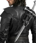 Back view of 2 In 1 Faux Leather Medieval Shoulder Armor With Back Sword Frog For LARP Cosplay, showing adjustable pauldrons and sword holster.