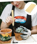 Person gardening with Wooden Garden Tool Handles Pack Of Five For Weeding And Mowing, shown in use with plants.