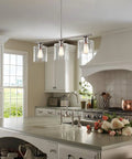 Sloane 31-Inch 3-Light Modern Industrial Farmhouse Island Light With Clear Glass Shades in kitchen setting