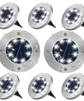 Set of eight upgraded solar ground lights with visible water droplets. Super bright, cool white, waterproof garden landscape feature.