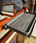 Super Sleek Aluminum RV Folding Wall Shelf With Hidden Drop Down Design, shown mounted beside a bed in a camper.