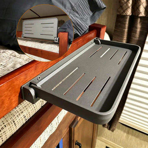 Super Sleek Aluminum RV Folding Wall Shelf With Hidden Drop Down Design, shown mounted beside a bed in a camper.
