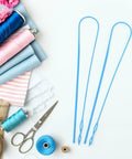 Flexible Plastic Drawstring Threader Tool Kit For Easy Threading Big Eye Design Works With Thick Or Thin Cords Grab And Go Portable 5 Pack Sewing Tool For Pants Hoodies Jackets Bags And Craft Projects. Blue plastic drawstring threaders with sewing supplies.