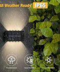 Six Pack Solar Outdoor Lights With 10 LED Waterproof Dusk To Dawn Fence Wall Deck Step Lighting Garden Pathway Yard Patio Warm White Glow For Outdoor Spaces in rain showcasing IP65 weather resistance.