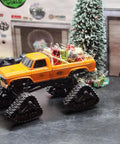 Orange RC truck with All Terrain Caterpillar Track Set 2Pcs For 1/18 FCX18 And 1/24 FMS RC Trucks, holiday decorations on bed