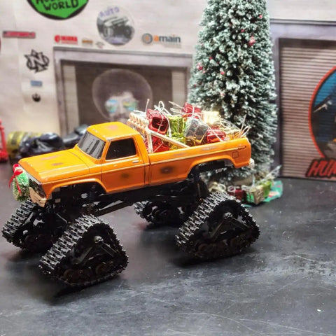 Orange RC truck with All Terrain Caterpillar Track Set 2Pcs For 1/18 FCX18 And 1/24 FMS RC Trucks, holiday decorations on bed