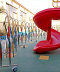 Built Different Stainless Steel Retractable Crowd Control Fence With Fast Roll Wheels Heavy Duty expandable fence beside red playground slide.