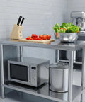Stainless Steel Workbench With Dual Tier Storage Rack, 31.5 By 20 Inches, shown in a kitchen with utensils and appliances.