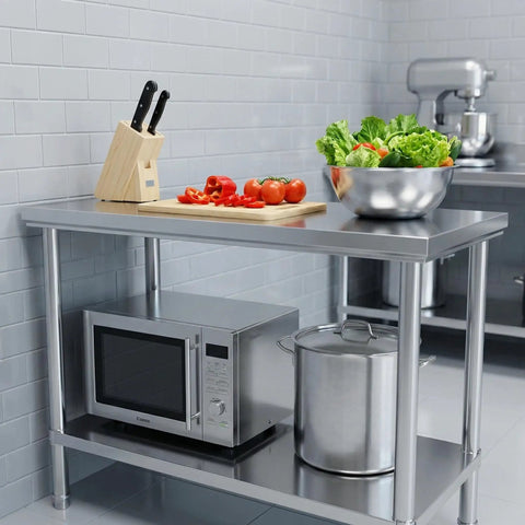 Stainless Steel Workbench With Dual Tier Storage Rack, 31.5 By 20 Inches, shown in a kitchen with utensils and appliances.