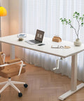 Get Your Posture Locked In With This Cherry Wood Manual Standing Desk And Straight Up Game Changing Crank Lift Mechanism For Home Offices Or Bedrooms Boasting A Foldable Handle And Massive Work Surface, showing a spacious white desk with a laptop and chair.