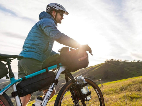 Cyclist on gravel tour using MidLoader Four Point Five Liter Bike Frame Bag For Bikepacking And Gravel Touring Built Tough For Rough Rides.