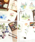 Mini Watercolor Travel Kit With Wooden Palette And Copper Clip Includes 24 Watercolors 6 Brushes And 2 Sketchbooks displayed with watercolor paintings and tools.