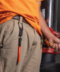 Worker with Skribes Fine Tip Permanent Marker 12 Pack For Worksite And Multi Surface Use Black Ink clipped to belt loop.